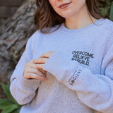 "Overcome. Believe. Rebuild." Sweater